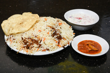 Chicken biryani. Spicy Indian Malabar biryani or Hydrabadi biryani, Dum Biriyani,  fish and rice. pulao basmati rice, spicy mixed rice dish with meat curry for Ramadan Kareem, Eid