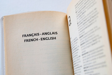 Inside pages of a French-English pocket dictionary. Concept for studying a second language,...