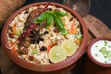 Chicken biryani. Spicy Indian Malabar biryani or Hydrabadi biryani, Dum Biriyani,  fish and rice. pulao basmati rice, spicy mixed rice dish with meat curry for Ramadan Kareem, Eid