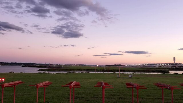Washington National Airport at sunset. Video shows Potomac river, the tower, runway, terminal buildings and an airplane taking off and going up.