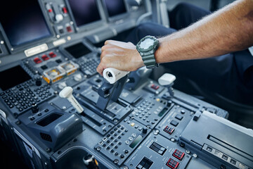 Male professional pilot taking off passenger plane