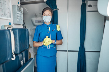 Beautiful stewardess working on board during pandemic