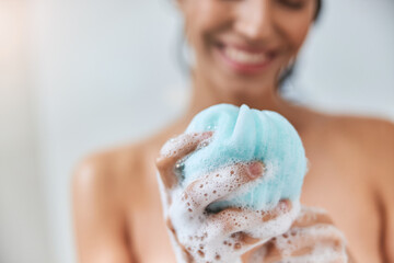Charming young woman holding bath loofah sponge