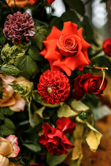 Juicy multicolored autumn wedding flowers collected in a large beautiful wedding decor in the woods