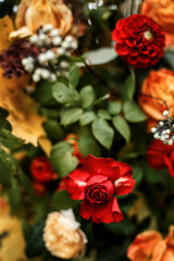 Juicy multicolored autumn wedding flowers collected in a large beautiful wedding decor in the woods