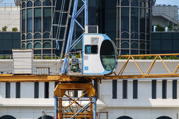 Crane operator cabin against the white building