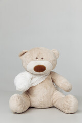 Teddy Bear animal with bandage as a symbol of children healtcare concept.