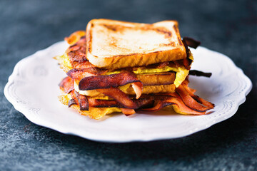 breakfast ham, bacon and egg sandwich