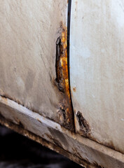 Rust on the body of a white car