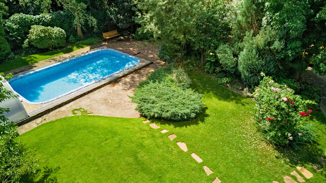 Swimming Pool In Beautiful Garden Aerial Top View
