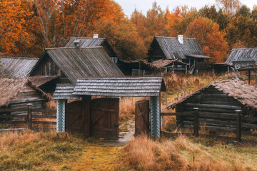 Wooden rustic houses in old village. Cloudy autumn day in a countryside mill village.