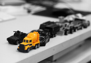 Cement truck toy color picture And many toy cars in black and white background images.