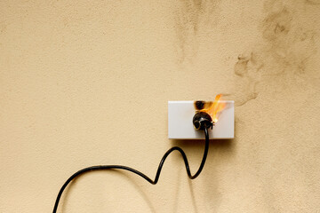 On fire electric wire plug Receptacle on the concrete wall background