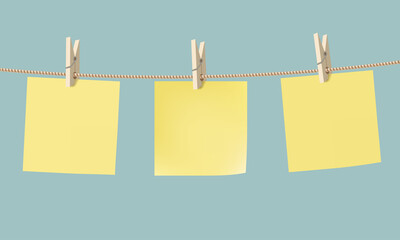 Yellow paper stickers hang on a rope with a clothespin