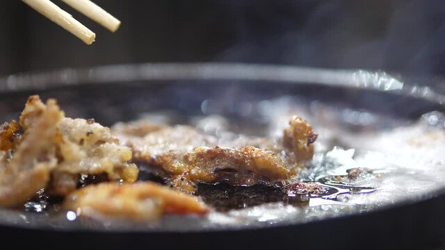 Fried pork on a pan with oil0, risk of cancer. healthy and fat concept.