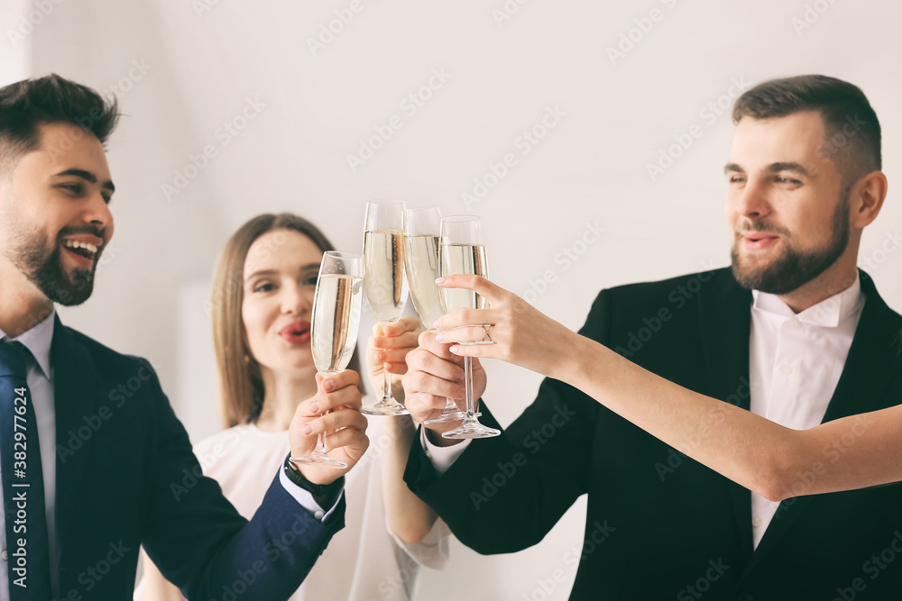 Sticker young people clinking glasses of tasty champagne at party in office