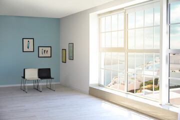 Interior of modern art gallery with big window