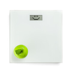 Scales with with happy emoticon on screen and apple on white background. Weight loss concept