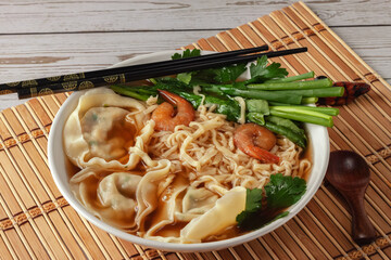 Shrimp noodle soup with wontons and spinach
