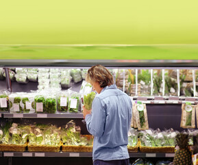 Young man buying vegetables at the market