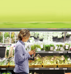 Young man buying vegetables at the market