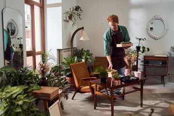 Florist gathering boxes with plants