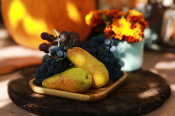 autumn still life with flowers, fruits and pumpkins