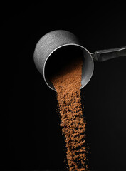 Pot with coffee powder on dark background
