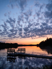 Naklejka premium Sunset over a lake at the pier