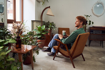 Florist sitting on chair drinking coffee