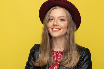 Closeup of happy fashion model wearing hat and smiling