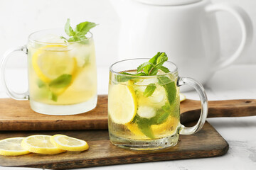 Cups of tasty cold ice tea on table