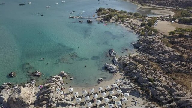 Aerial drone video of sandy beach blue sea water, clear blue sky Paros island Cyclades, Greece