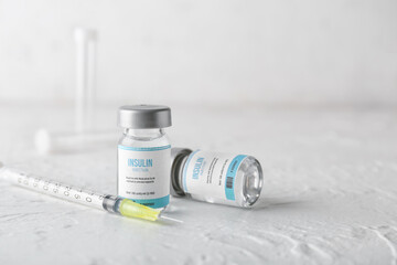 Bottles of insulin with syringe on white background. Diabetes concept