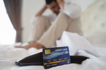 stressed Asian man with debt of credit card and all bills. Financial problem concept.    