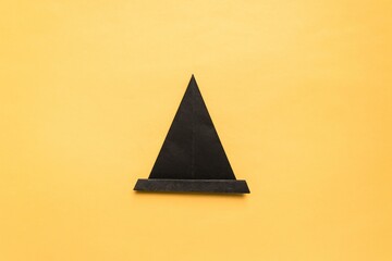 Fototapeta premium Step by step photo instruction how to make origami paper hat. Halloween hat of witch. Simple diy with kids children's concept.