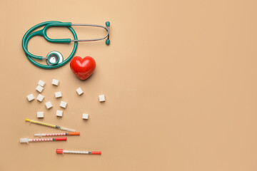 Stethoscope with heart, sugar cubes and syringes on color background. Diabetes concept