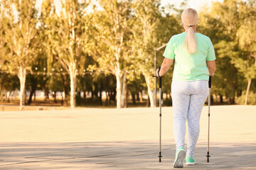 Mature woman with walking poles outdoors