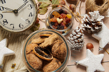 christmas decoration in rustic style and holiday background, still life on wooden backdrop, bread, nuts and other