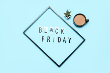 Text BLACK FRIDAY and cup of coffee on color background