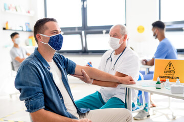 Obraz premium Man with face mask getting vaccinated, coronavirus, covid-19 and vaccination concept.