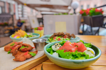 Table with food and drink. Table covered with food, different kinds of salad, deep fried beer snack.