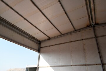 Sandwich panel. Industrial warehouse construction and interior view of the roof ceiling structure. Muscat