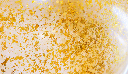 Close up piece of gold colour paper in balloon. User for party decoration, background and texture