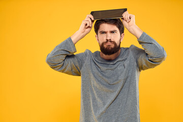 Bearded man with tablet in hands technology work wireless device yellow background