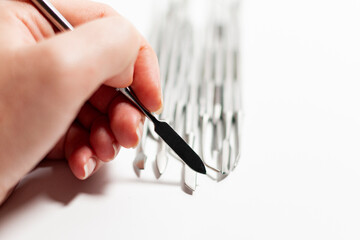 Manicure spatula on the background of a group of scrapers and pushers.