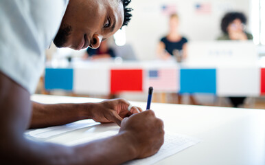 African-american man voter in polling place, usa elections concept. - Powered by Adobe