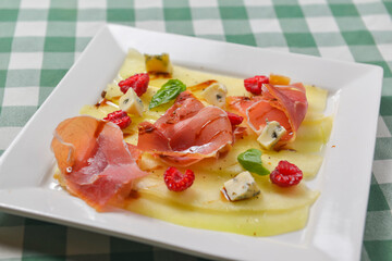 Delicious appetizer, cheese and prosciutto salad. Traditional Italian cuisine, Italian concept.