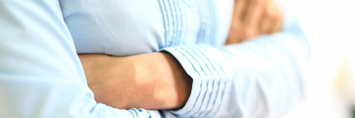 Woman stands with folded arms on her chest. Equal rights between woman and man concept