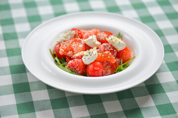 Tomato and salmon salad with cheese and spices. Traditional Italian cuisine, Italian concept.